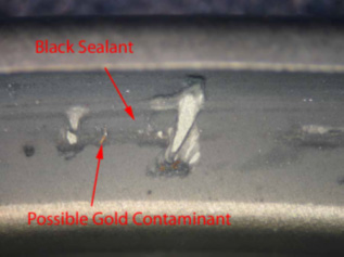 black sealant and gold contaminant